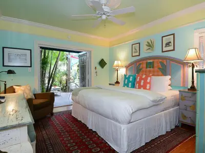 a bedroom with a bed and a living room at Pineapple Point Guesthouse & Resort - Gay Men's Resort in Fort Lauderdale