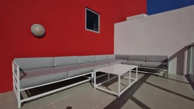 a living room with a couch and a red wall at Modern Penthouse condo with 2 Large private terraces in Hollywood