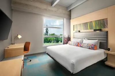 a bedroom with a large bed and a window at Aloft Miami Airport in Miami