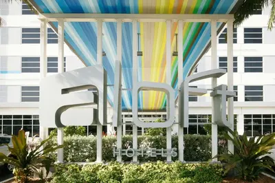 a large sign in front of a building at Aloft Miami Airport in Miami