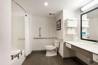 a white bathroom with a toilet and a sink at Hampton Inn & Suites Miami Wynwood Design District, FL in Miami