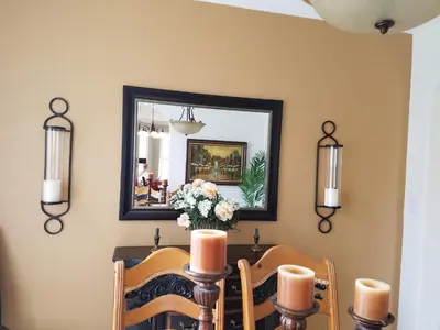 a dining room with a table and a mirror at My Florida Lake House in Homestead