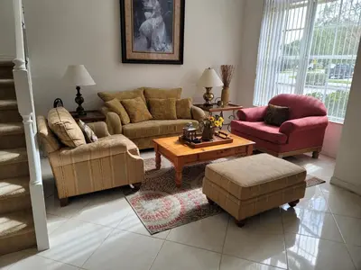 a living room with two couches and a coffee table at My Florida Lake House in Homestead