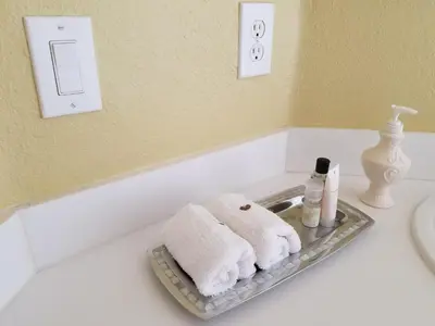 a bathroom with two towels on a tray next to a bathtub at My Florida Lake House in Homestead