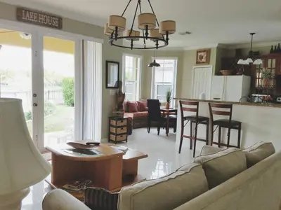 a living room with a couch and a table at My Florida Lake House in Homestead