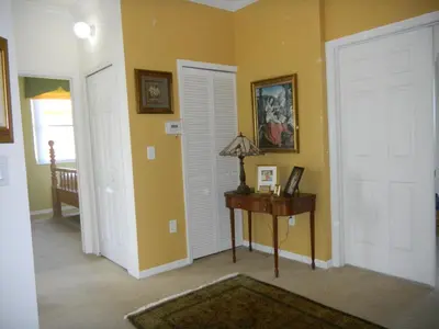 a room with two doors and a table with a lamp at My Florida Lake House in Homestead
