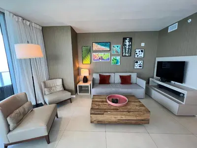 a living room with a couch and a tv at Luxury Beach Resort in Hollywood