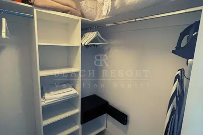 a walk in closet with white shelves in a room at Luxury Beach Resort in Hollywood