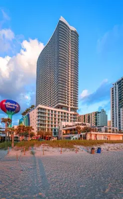 a beach with a large building in the background at Luxury Beach Resort in Hollywood