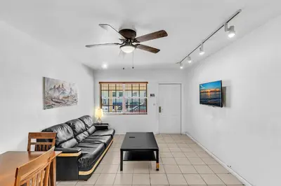 a living room with a couch and a ceiling fan at The Sunrise in Hollywood