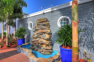 a rock fountain in front of a building at May-Dee Suites in Florida in Hollywood