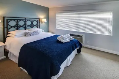 a bedroom with a large bed and a window at May-Dee Suites in Florida in Hollywood