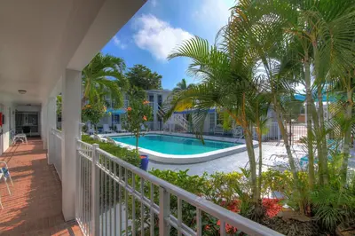 a view of the pool from the balcony of a resort at May-Dee Suites in Florida in Hollywood