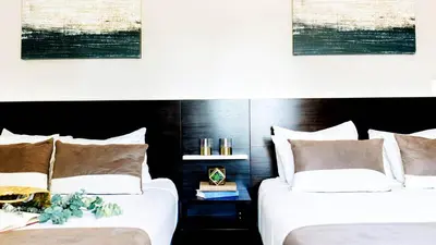 two beds sitting next to each other in a bedroom at Casa Boutique Hotel in Miami Beach