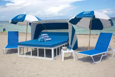 two chairs and an umbrella on the beach at Casa Boutique Hotel in Miami Beach