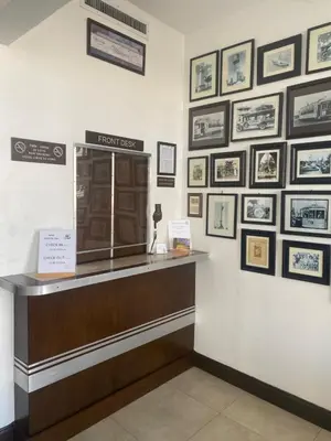 a cashier counter with framed pictures on the wall at Hotel Ponce de Leon in Miami