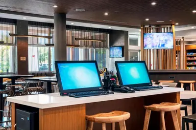 two laptop computers sitting on a counter in a restaurant at SpringHill Suites by Marriott Miami Doral in Miami