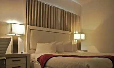 a hotel room with a bed with two lamps at The Fritz Hotel in Miami Beach