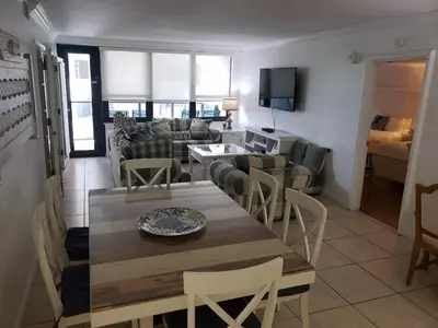 a living room with a table and a couch at 2 Bedroom 2 Bath Beachfront Condo on Miami Beach Millionaire Row in Miami Beach