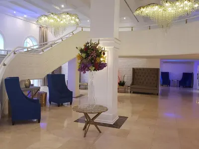 a lobby with a staircase and a table and chairs at 2 Bedroom 2 Bath Beachfront Condo on Miami Beach Millionaire Row in Miami Beach
