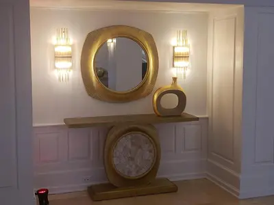 a mirror on a wall next to a table with a clock at 2 Bedroom 2 Bath Beachfront Condo on Miami Beach Millionaire Row in Miami Beach