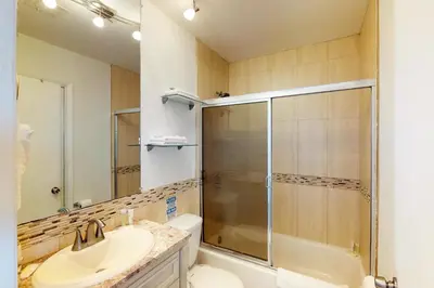 a bathroom with a shower and a sink and a toilet at Castle Beach: Rumba Suite in Miami Beach