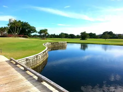 a pond of water next to a wooden bridge at On The Beach - Lux 2 Bedroom Miami in Hollywood