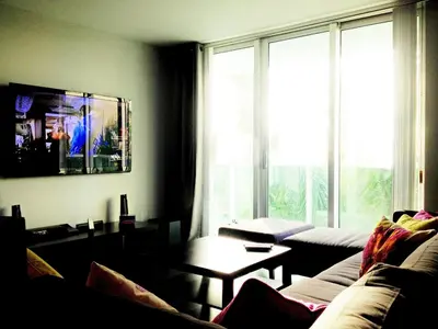 a living room with a couch and a large window at On The Beach - Lux 2 Bedroom Miami in Hollywood