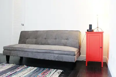 a couch in a living room with a red table at On The Beach - Lux 2 Bedroom Miami in Hollywood