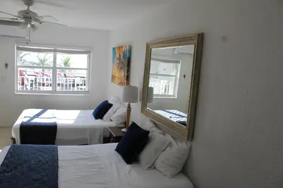 a hotel room with two beds and a mirror at Golden Sand Oceanfront in Hollywood
