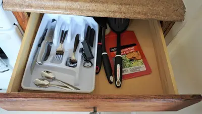 a drawer filled with utensils in a cabinet at Golden Sand Oceanfront in Hollywood