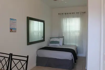 a small bedroom with a bed and a mirror at Golden Sand Oceanfront in Hollywood