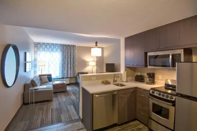 a kitchen and living room with a couch and a kitchen at TownePlace Suites by Marriott Miami Airport in Miami