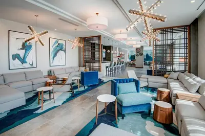 a living room with couches and chairs and tables at TownePlace Suites by Marriott Miami Airport in Miami