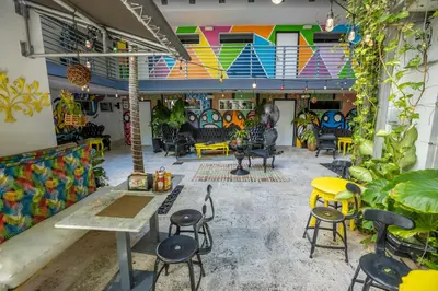 a room with chairs and tables and colorful walls at Riviera Suites in Miami Beach