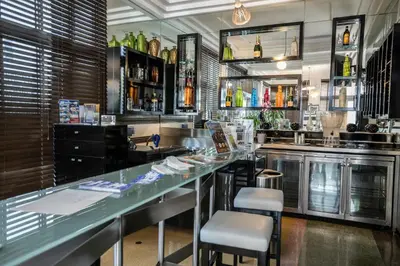 a bar with two stools and a counter at Riviera Suites in Miami Beach