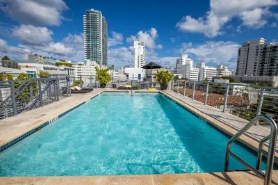 a swimming pool on top of a building with a city skyline at Riviera Suites in Miami Beach