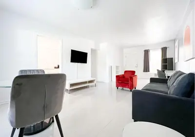 a living room with a couch and a red chair at Winterset in Fort Lauderdale