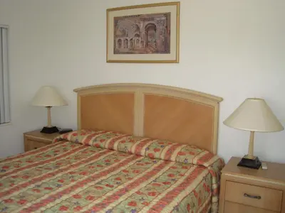 a bedroom with a bed and two night stands with lamps at Summerland Suites in Fort Lauderdale