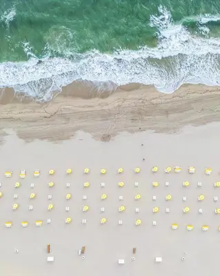 an overhead view of a beach with umbrellas and the ocean at The Lago Mar Beach Resort and Club in Fort Lauderdale
