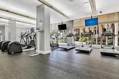 a gym with cardio machines and a flat screen tv at The Tides 1bedroom apt 3rd floor We are on the Beach! in Hollywood