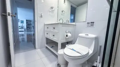a white bathroom with a toilet and a shower at THE TIDES 2bedrooms apt 14th floor WE ARE ON THE BEACH! in Hollywood