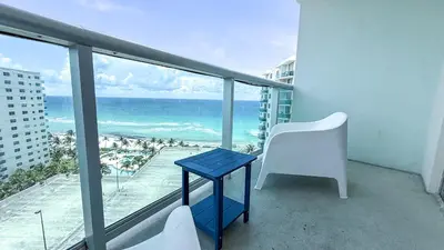 a blue table and a chair on a balcony with the ocean at THE TIDES 2bedrooms apt 14th floor WE ARE ON THE BEACH! in Hollywood