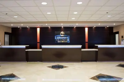 a waiting room with a sign on the wall at Clarion Inn & Suites Miami International Airport in Miami