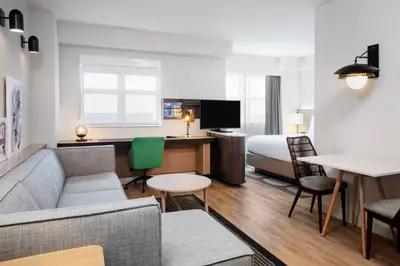 a hotel room with a couch and a bed and a desk at Residence Inn by Marriott Miami Aventura Mall in Aventura
