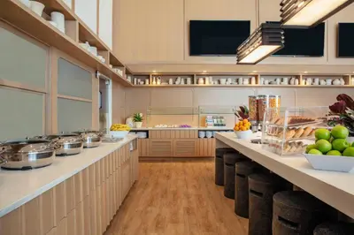 a large kitchen with a counter with food on it at Residence Inn by Marriott Miami Aventura Mall in Aventura