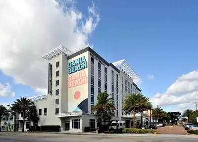a large white building with a sign on it at Hotel Dello Ft Lauderdale Airport, Tapestry Collection by Hilton in Dania Beach