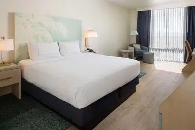 a large white bed in a hotel room at Hotel Dello Ft Lauderdale Airport, Tapestry Collection by Hilton in Dania Beach