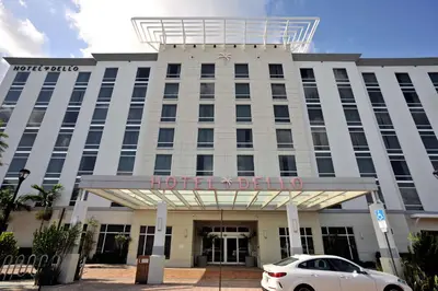a white car parked in front of a hotel building at Hotel Dello Ft Lauderdale Airport, Tapestry Collection by Hilton in Dania Beach