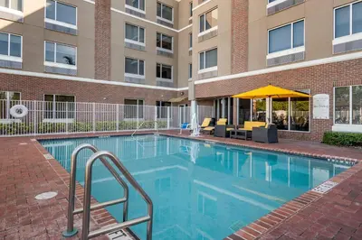 a swimming pool in front of a building at Cambria Hotel Ft Lauderdale, Airport South & Cruise Port in Dania Beach